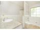 Bright bathroom with a large window, combination shower-tub, and ample counter space at 2695 Virginia Cv, South Fulton, GA 30296