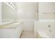 Bathroom with a tiled floor, large mirror, granite countertop vanity, and a bathtub at 2695 Virginia Cv, South Fulton, GA 30296