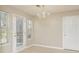 Bright dining area with an elegant chandelier, and access to the backyard at 2695 Virginia Cv, South Fulton, GA 30296