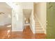 Open foyer with wood-look flooring, staircase, and views into the kitchen and living areas at 2695 Virginia Cv, South Fulton, GA 30296