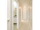 Well-lit hallway featuring neutral tones, carpet flooring, and access to various rooms at 2695 Virginia Cv, South Fulton, GA 30296