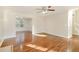 Bright living room with hardwood floors, ceiling fan, and natural light, creating an inviting atmosphere at 2695 Virginia Cv, South Fulton, GA 30296