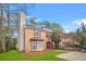 Brick townhouse featuring a bay window and manicured lawn with mature trees at 1751 Twin Brooks Se Dr, Marietta, GA 30067