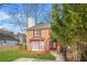 Traditional townhouse with brick facade, red accents and a neat front yard at 1751 Twin Brooks Se Dr, Marietta, GA 30067