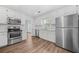 Modern kitchen with stainless steel appliances, white cabinets, and hardwood flooring at 1751 Twin Brooks Se Dr, Marietta, GA 30067