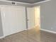 Bedroom with an open closet, white doors, and a sleek hard-surface flooring at 3083 Colonial Way # N, Atlanta, GA 30341