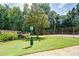 Outdoor dog park with grassy lawn, waste station and trees at 3083 Colonial Way # N, Atlanta, GA 30341