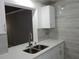 Kitchen featuring white cabinets and stainless-steel sink with breakfast bar at 3083 Colonial Way # N, Atlanta, GA 30341