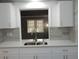 Kitchen with a sink and view to the adjacent living space through a pass-through window at 3083 Colonial Way # N, Atlanta, GA 30341