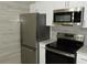 Close-up of kitchen featuring stainless steel appliances and white cabinets at 3083 Colonial Way # N, Atlanta, GA 30341