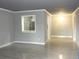 Open living room featuring sleek gray walls, modern flooring, and a pass-through window to the kitchen at 3083 Colonial Way # N, Atlanta, GA 30341