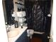 Stylish bathroom features a vanity with sink, a mirrored wall, a metal shelf, and a tub shower with a black curtain at 3738 Windy Hill Se Dr, Conyers, GA 30013