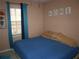 Bedroom featuring neutral-colored walls, window with curtains, and a comfortable bed with blue comforter at 3738 Windy Hill Se Dr, Conyers, GA 30013