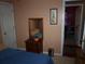 Bedroom featuring a dresser with mirror, and bed with blue comforter; doorway view to another room at 3738 Windy Hill Se Dr, Conyers, GA 30013