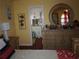 Bedroom with bright yellow walls, dresser with round mirror, and a view into the attached bathroom at 3738 Windy Hill Se Dr, Conyers, GA 30013