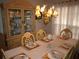 Elegant dining room with beautiful china cabinet and a table set for six at 3738 Windy Hill Se Dr, Conyers, GA 30013