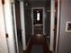 Hallway with hardwood floors and gray walls, connecting various rooms and leading to a living space at 3738 Windy Hill Se Dr, Conyers, GA 30013