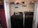 Functional laundry room with modern black washer and dryer units and practical storage solutions at 3738 Windy Hill Se Dr, Conyers, GA 30013