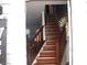 A staircase features wooden steps and railing with carpet at the bottom at 3738 Windy Hill Se Dr, Conyers, GA 30013