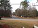 Scenic view of the street surrounded by tall trees and well-maintained greenery at 3738 Windy Hill Se Dr, Conyers, GA 30013