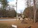 View of the front yard and street showing mature trees providing a park-like setting at 3738 Windy Hill Se Dr, Conyers, GA 30013