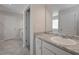 A bathroom featuring a vanity with granite counters and a view of the bathtub at 455 Charleston Pl, Villa Rica, GA 30180