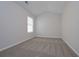 This bedroom features neutral walls, carpeted floors, and a window for natural light at 455 Charleston Pl, Villa Rica, GA 30180