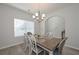 Bright dining room featuring modern chandelier, stylish table set, and plenty of natural light through a window at 455 Charleston Pl, Villa Rica, GA 30180