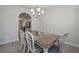 Cozy dining area featuring a chandelier, wood floors, and an archway to the kitchen at 455 Charleston Pl, Villa Rica, GA 30180