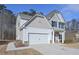 Stylish two-story home with a two-car garage, concrete driveway, and inviting front entrance at 455 Charleston Pl, Villa Rica, GA 30180