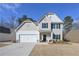 Charming two-story home featuring a two-car garage, well-maintained lawn, and classic curb appeal at 455 Charleston Pl, Villa Rica, GA 30180