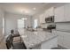 Contemporary kitchen featuring island with seating, modern appliances, and granite countertops at 455 Charleston Pl, Villa Rica, GA 30180