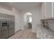 Well-equipped kitchen with stainless steel refrigerator and leads to dining area, enhancing convenience and flow at 455 Charleston Pl, Villa Rica, GA 30180