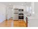 Modern kitchen features stainless steel appliances, white cabinets, and hardwood floors at 107 Chappell Sw Rd, Atlanta, GA 30314