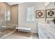 This bathroom offers a glass shower and a bright window above the bench at 1121 Rivard Nw Cir, Atlanta, GA 30318