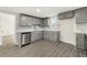 Well-lit kitchen with gray cabinets, stainless steel appliances, and gray flooring at 2331 Luther St, Lithonia, GA 30058