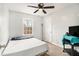 Comfortable bedroom with natural light from a window and a ceiling fan at 620 Bell Se Rd, Conyers, GA 30094