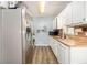 Efficient kitchen with wood countertop, white cabinetry, and stainless steel refrigerator at 620 Bell Se Rd, Conyers, GA 30094