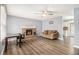 Comfortable living room with a brick fireplace, ceiling fan, and wood laminate flooring at 620 Bell Se Rd, Conyers, GA 30094