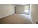 Spacious bedroom with plush gray carpeting and lots of natural light from the bright window at 66 Pine Creek Ct, Dallas, GA 30157