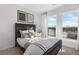 Bright bedroom featuring a dark wood bed frame, natural light from two large windows, and simple, modern decor at 1119 Rivard Nw Cir, Atlanta, GA 30318