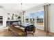 A dining room featuring three windows, a dining table with chairs and benches, and hardwood floors at 1119 Rivard Nw Cir, Atlanta, GA 30318