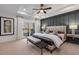 Relaxing main bedroom with a padded headboard, tray ceiling, board and batten wall, and balcony access at 1119 Rivard Nw Cir, Atlanta, GA 30318