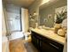 Stylish bathroom featuring a large vanity, decorative mirror, and shower-tub combo at 139 Concord Place, Hiram, GA 30141