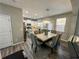 Elegant dining area with a stylish chandelier open to a modern, well-equipped kitchen at 139 Concord Place, Hiram, GA 30141