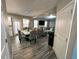 Open-concept dining area flowing into the living room, with a modern table and chairs at 139 Concord Place, Hiram, GA 30141