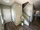 View of entryway showcasing hardwood floors, staircase, and access to other rooms at 139 Concord Place, Hiram, GA 30141