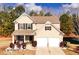 Charming two-story home featuring a manicured front yard and an attached two-car garage at 139 Concord Pl, Hiram, GA 30141