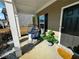 Cozy covered front porch with hanging chairs, lush greenery, and a modern front door at 139 Concord Pl, Hiram, GA 30141