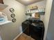 Practical laundry room featuring modern appliances and storage shelving at 139 Concord Place, Hiram, GA 30141